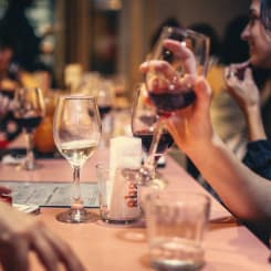 a man holds a glass of wine at the table